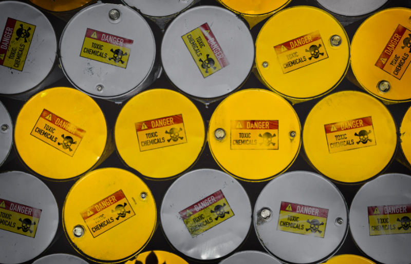 Eco-friendly paint - free image from canva of metal barrels labelled "toxic chemicals'