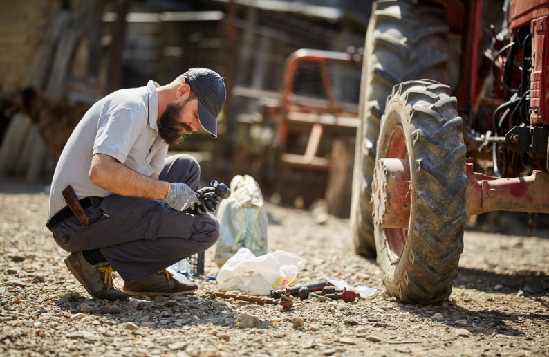 Living off the grid - free image from canva of a man fixing machinery on a farm