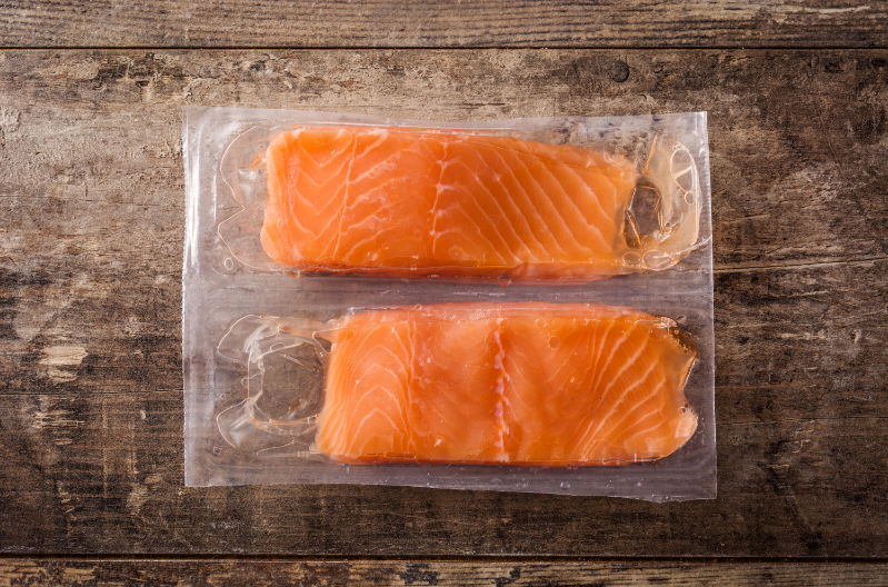 wild-caught fish - stock image from Canva of two vacuum packed salmon fillets on a wood board