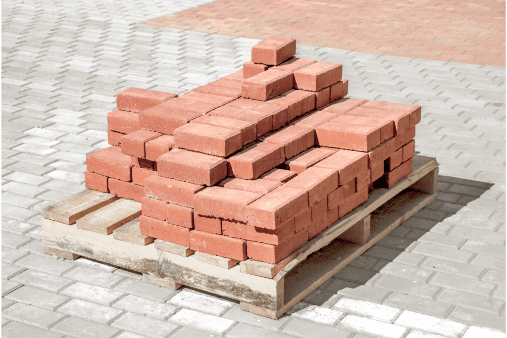 Storing building materials - small stack of red bricks piled on a wooden pallet