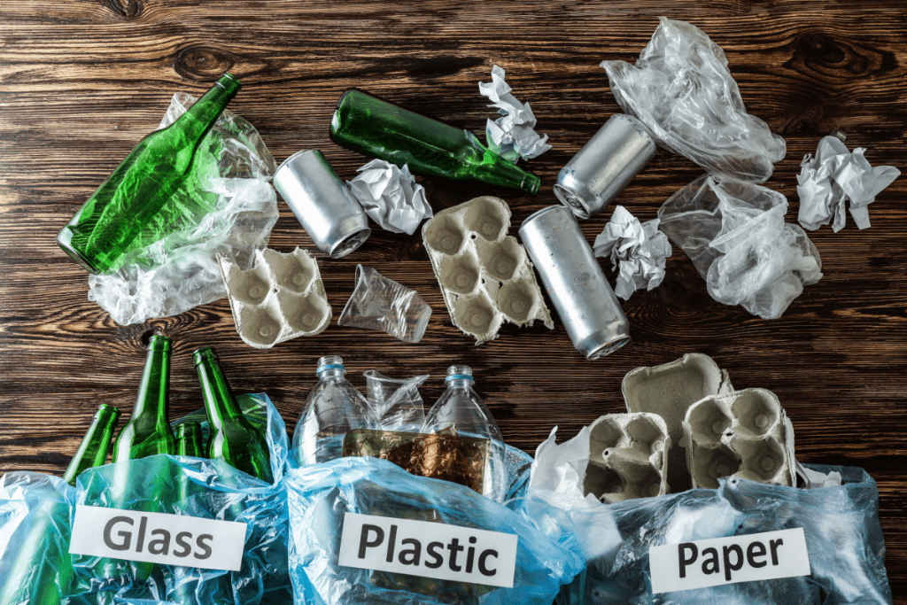 Teaching kids about sustainability - sorting recycling into glass, paper, and plastic