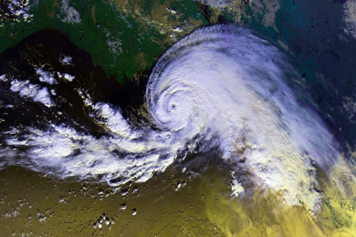 seismic phenomena - hurricanes and earthquakes - image of a hurricane from above over land