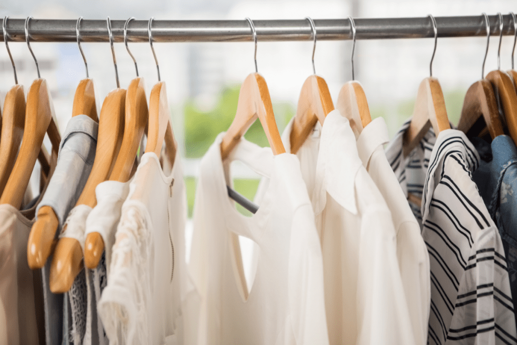 Low-waste Lifestyle - Image of neutral coloured clothing on a minimalist looking clothing rail