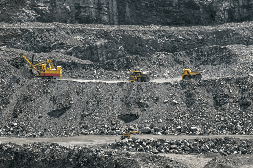 Ethical jewelry - stock image from Canva of yellow diggers looking tiny in a huge open cast mine