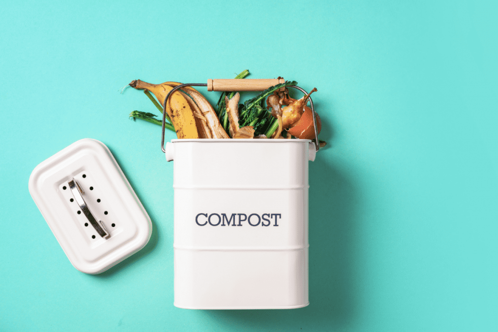 Zero-Waste Tips - enamel composting bin with food scraps on a bright blue background 