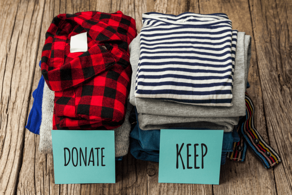 Sustainable decluttering - piles of folded clothes with signs that say "donate" and "keep" on them