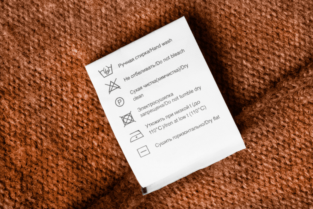 Sustainable and ethical fashion - shop your closet for forgotten gems - stock image of the care label inside a knitted garment