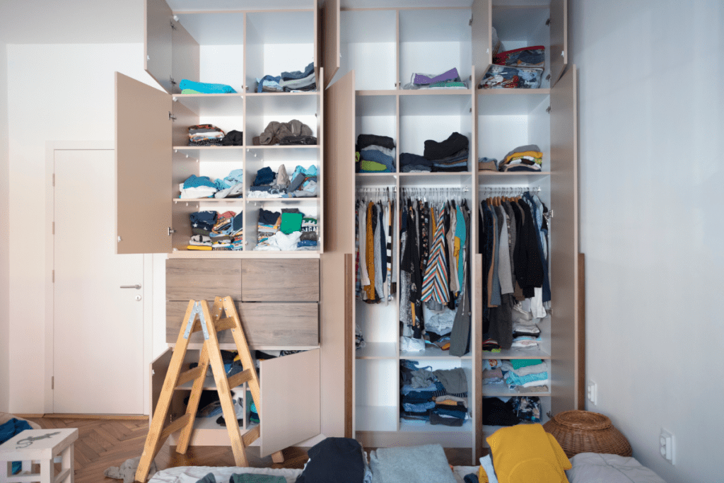 Sustainable and ethical fashion - shop your closet for forgotten gems - stock image of an open closet stuffed with clothes