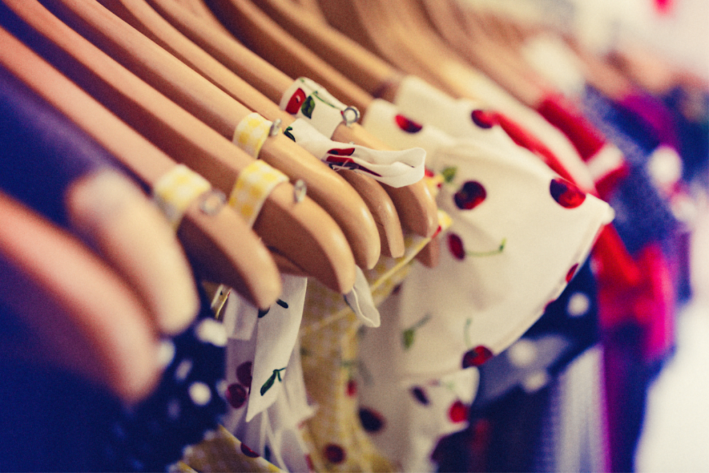 Sustainable fashion - Selection of Vintage cap sleeve dressed on wooden clothes hangers on a rail