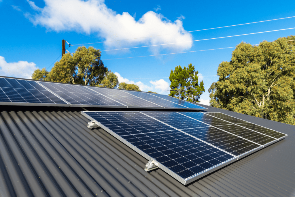 Energy-efficient home: image of solar panels on the roof of a house with a sunny sky in the background