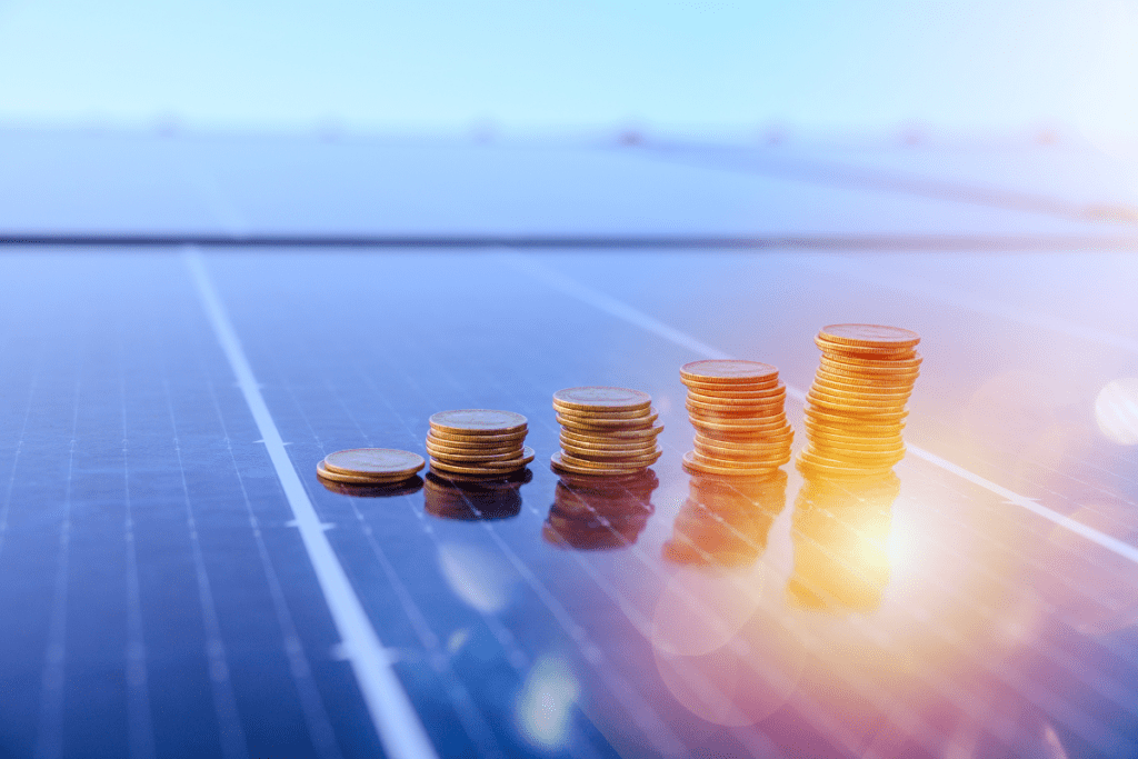 Solar Panel with little piles of coins on it in the sunshine