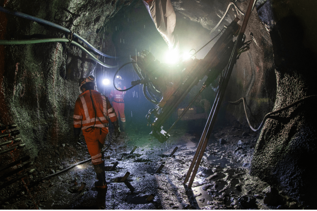Weather Forecasting - Miners in the rain and mud at the entrance to a mine shaft
