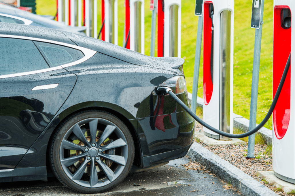 Electric Vehicles - Stock image from Canva of an electric vehicle charging at a charging station