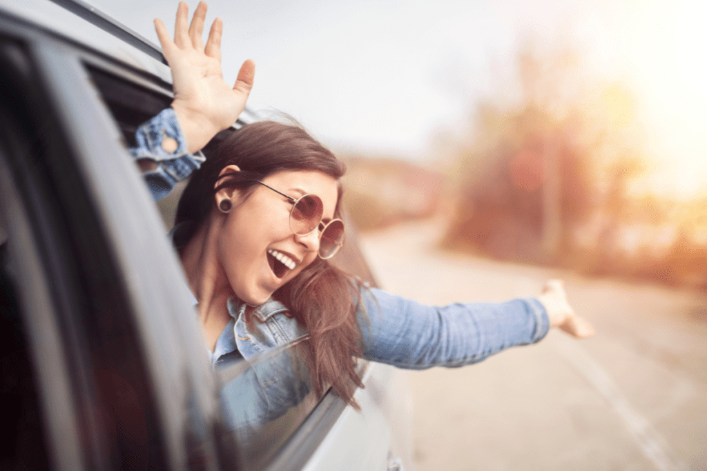 Eco-friendly Car Owner - smiling woman out car window