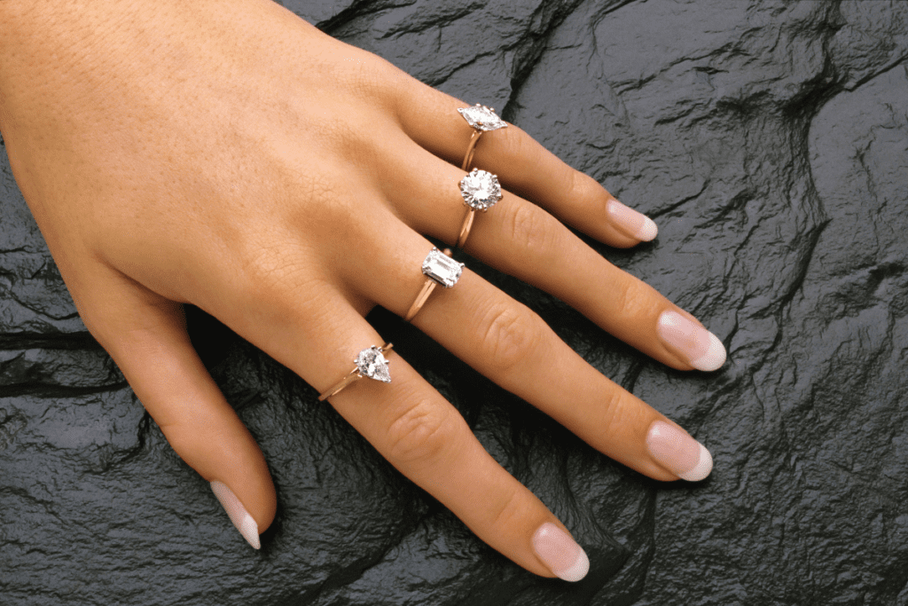 Lab-grown Diamonds - stock image of a womans hand with a different diamond ring on each finger