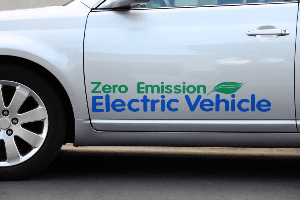 Adoption of EVs - Stock image from Canva of a silver car with "Zero Emission Electric Vehicle" written on the side