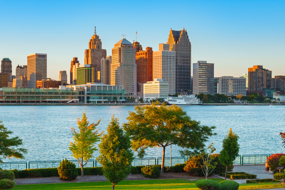Greening of Detroit - Stock Image from Canva of the Detroit MI skyline with trees and the river in the foreground