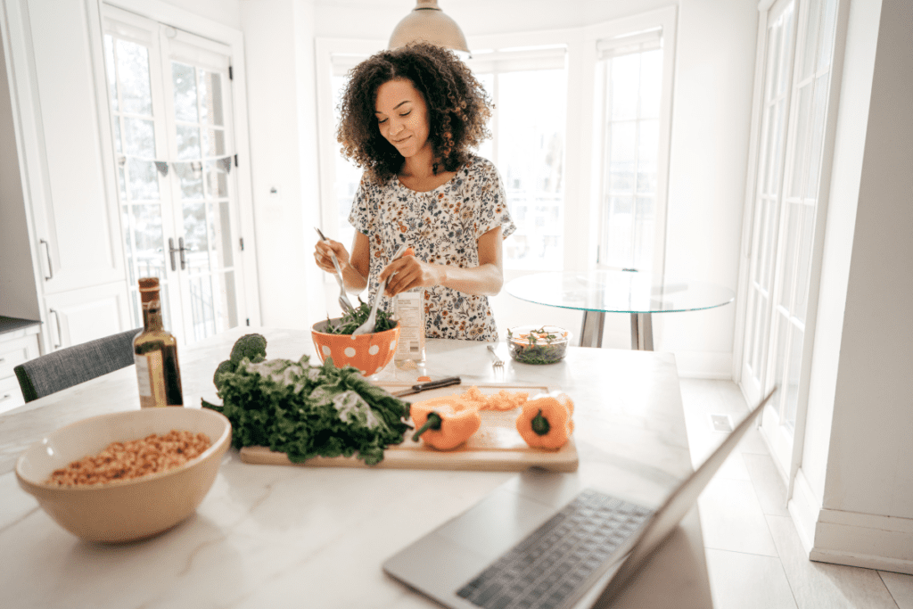 woman preparing a meal using vegetables