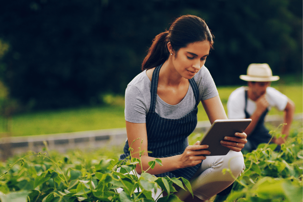Gardener using an electronic tablet in the garden