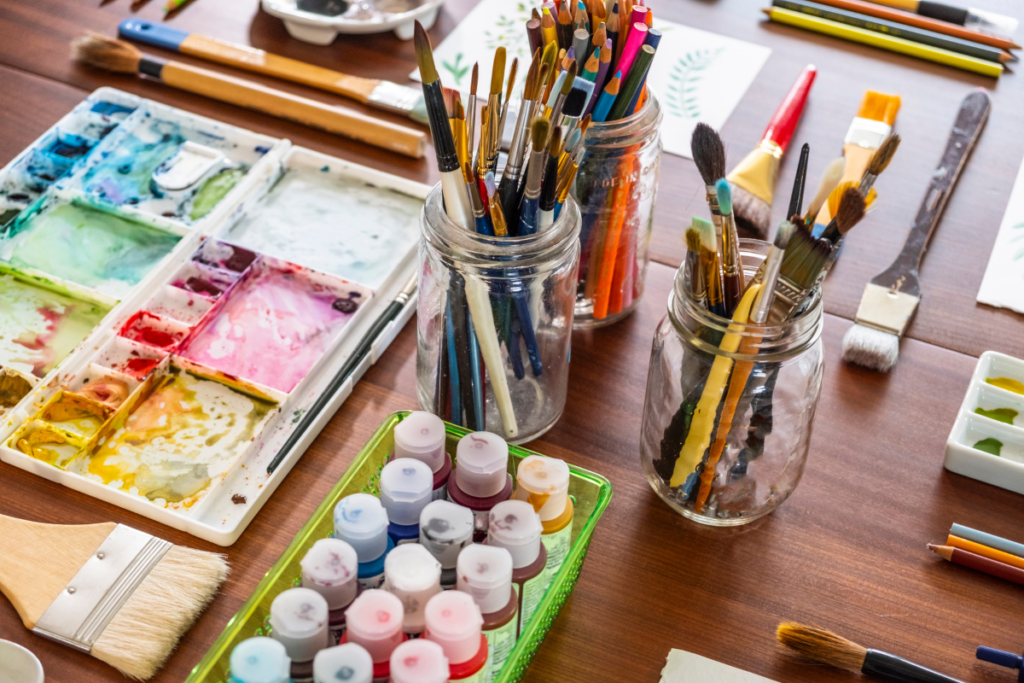 Eco-friendly Painting Practices - various paints and brushes on a table