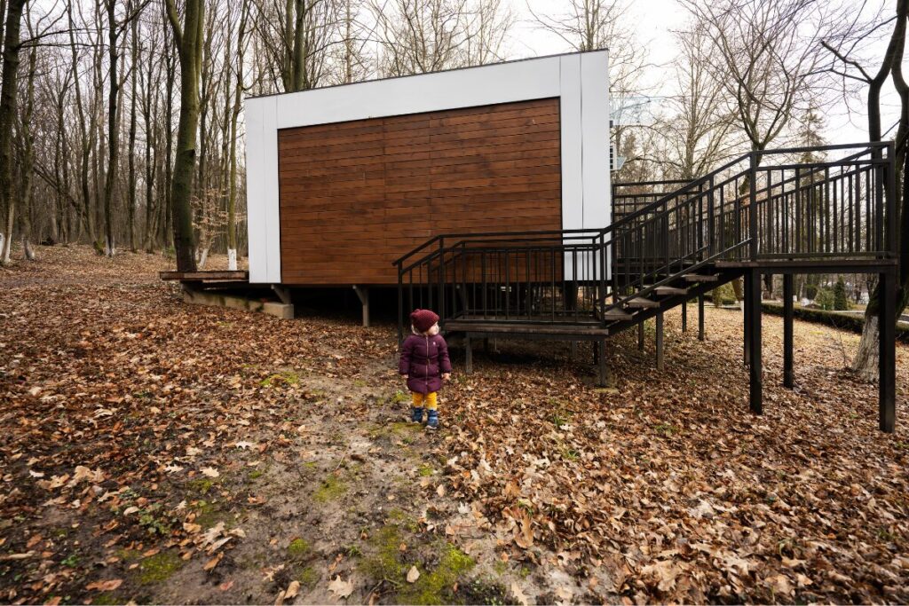 A completed modular home painted in white and wood color