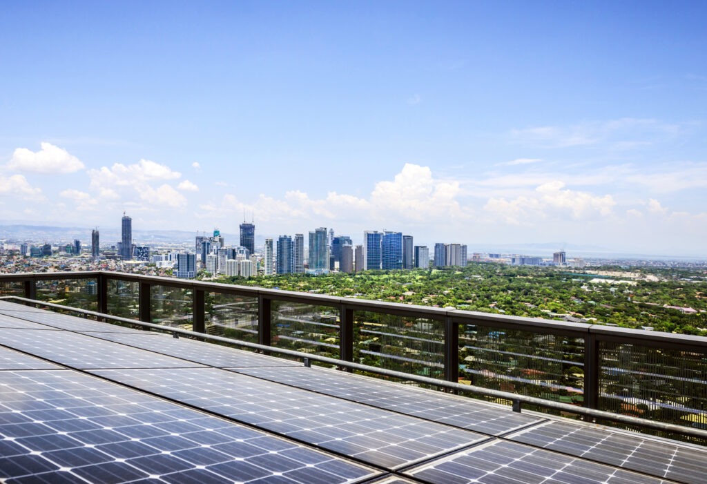 Manila,Philippines,Solar panels and Manila cityscape under blue sky, Philippines