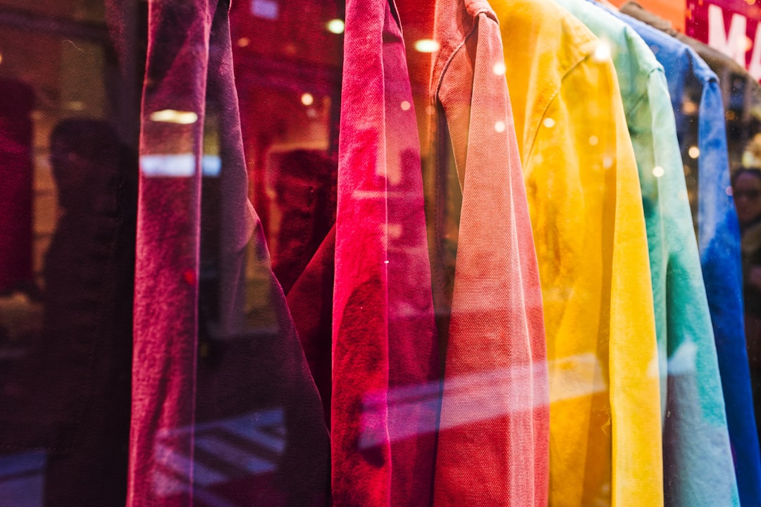a row of colorful ties hanging in a store window